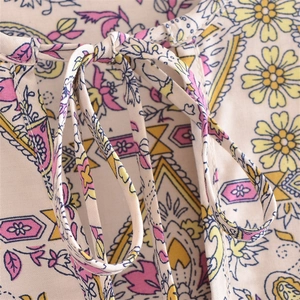 Women's V-neck dress featuring Bohemian floral patterns and tie-up tassel neckline details