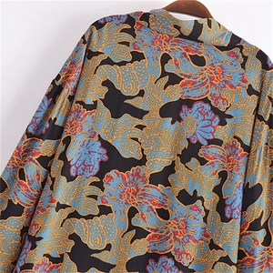 Close-up of vintage floral print fabric on a loose cardigan with intricate patterns