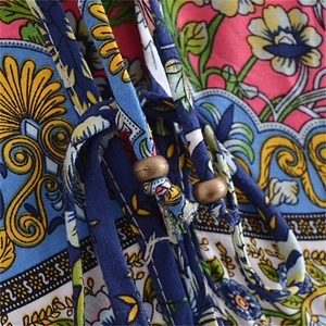 Close-up of bohemian floral pattern and drawstring with vintage bronze beads detail