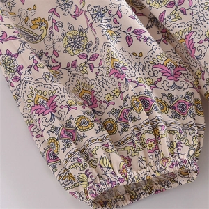 Detail of bohemian floral paisley print dress with elastic cuffs and lightweight fabric