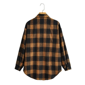 Classic brown and black plaid flannel shirt with drop shoulder and curved hem detail