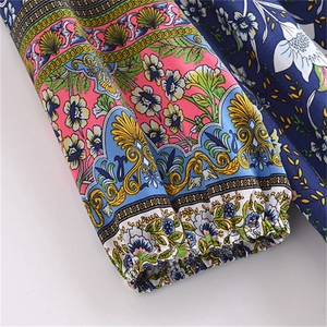 Detail of elastic cuff on bohemian floral print dress with vibrant ethnic pattern