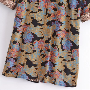 Detail of floral print pattern and leopard leopard patchwork cuff on long sleeve cardigan