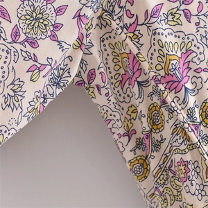Close-up of floral paisley print detail on a soft V-neck rayon bohemian dress fabric