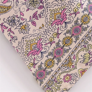 Close-up of bohemian floral paisley print fabric with detailed edge stitching