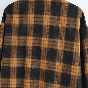 Close-up of the vintage brown checkered pattern and texture on this flannel cotton shirt