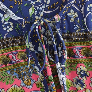 Bohemian V-neck dress with colorful floral patterns and tassels in a loose tunic style