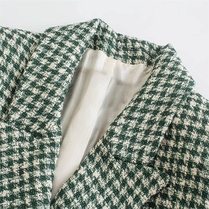 Women's green houndstooth tweed blazer with double-breasted buttons and notch lapel