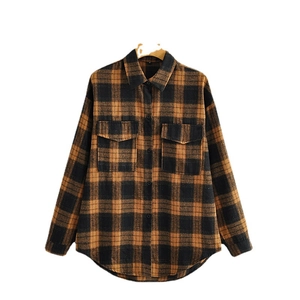 Brown and black oversized plaid flannel shirt with front chest pockets on wooden hanger