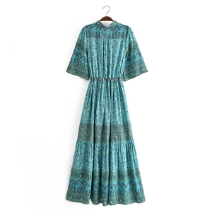 Detail of bohemian maxi dress showing ethnic elephant prints and deep blue tassel waist ties