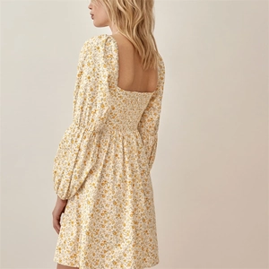 Close-up of smocked back detail and floral print on yellow square neck long sleeve dress