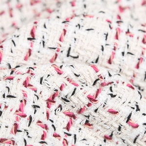 Close-up of premium pink, white and black woven tweed fabric texture for outerwear