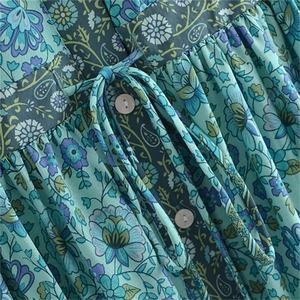 Detail view of bohemian floral print fabric with drawstring waist and small white buttons