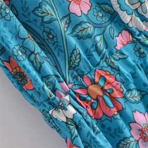 Detail of blue floral print fabric with elastic smocking and bohemian pattern