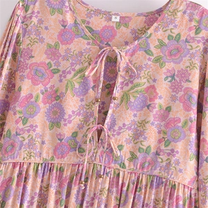 Bohemian floral V-neck tunic dress with tassel ties and vibrant summer prints