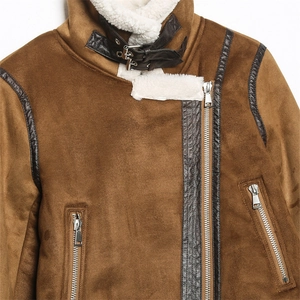 Detail of dark brown faux suede jacket featuring white faux fur lining and buckle straps