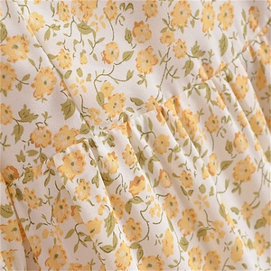 Macro detail of French vintage floral chiffon fabric with pleats and small yellow flowers