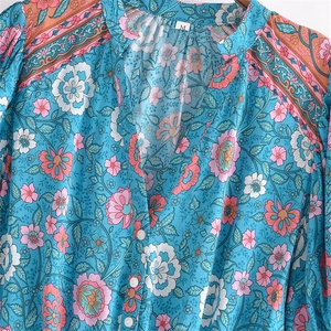 Bohemian floral V-neck dress in vibrant lake blue with pink blossom prints and tassel details