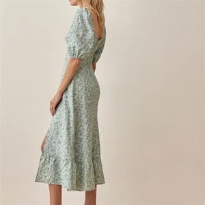 Detail view of floral midi dress with puff sleeves and side slit design in light green