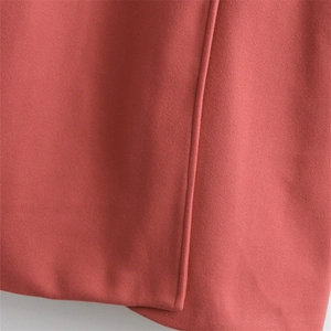 Classic double-breasted woolen coat in burnt orange with premium stitching detail