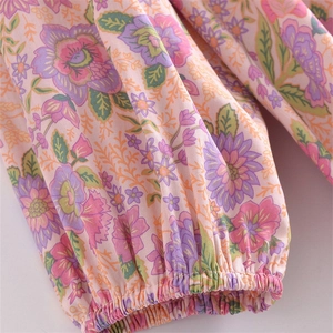 Detail of elastic cuff and vintage floral print on lightweight woven fabric sleeve
