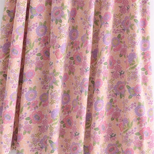 Close-up of soft floral pattern and drapey fabric texture on the V-neck dress