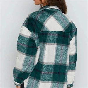 Detail view of the back seams and plaid pattern on this green wool blend shirt jacket