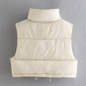 Detail of the back of a beige quilted vest with stand collar and adjustable drawstring hem