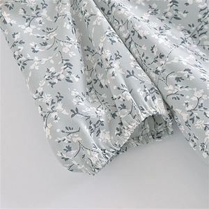 Close-up of elastic ruffled cuffs and floral print on a French retro style dress