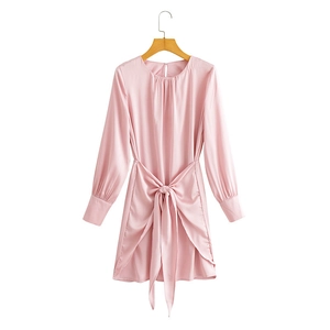 Pink satin long sleeve dress with waist tie and round neck on wooden hanger