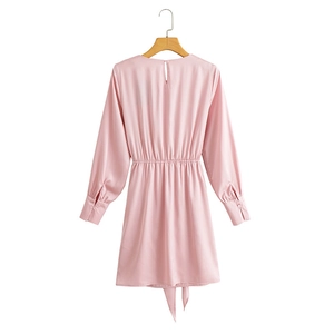 Pink long sleeve slim fit dress featuring a back button closure and waist pleat detail