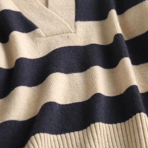 Navy and beige striped V-neck knit sweater with classic ribbed hem and textured finish
