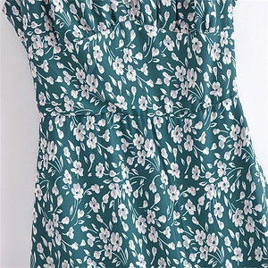 Détail de la robe à fleurs vert foncé avec coupe à taille haute et texture volantée
