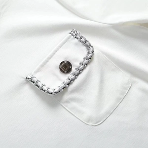 White Y2K style knit t-shirt with textured tweed pocket detail and vintage metal button
