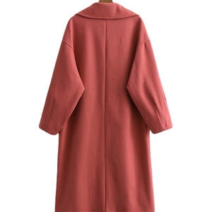 Classic double-breasted woolen cocoon coat in brick red with a minimalist loose silhouette