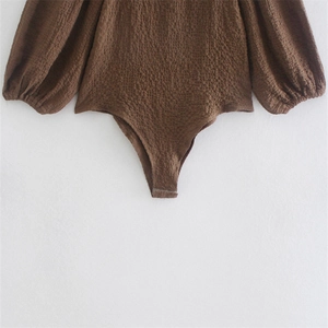 Deep brown slim fit bodysuit with puff sleeves and textured seersucker fabric finish