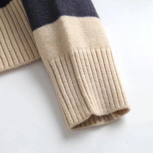 Macro shot of navy blue and white striped ribbed cuffs on a knit polo shirt