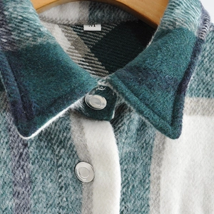 Detail of the turquoise plaid wool shirt jacket collar with metal snap buttons and M label