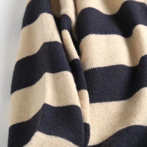 Close-up of black and cream striped knit fabric showing soft texture and fine stitching