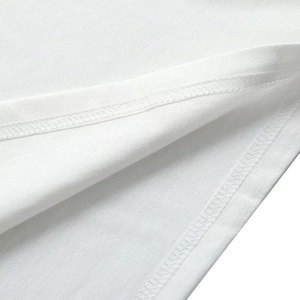 Detailed macro shot of white knit fabric with professional double-needle stitching and texture