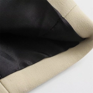 Close-up of premium stitching and lining on a solid beige oversized blazer jacket