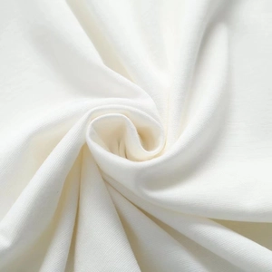 Macro view of white knitted fabric texture showing soft cotton fibers and weave detail