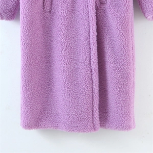 Close-up of the thick purple teddy fleece texture on the warm long winter coat