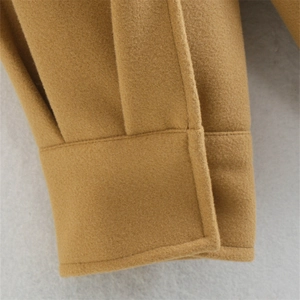 Close-up of camel wool fabric texture and neat stitching on a thick shirt jacket sleeve