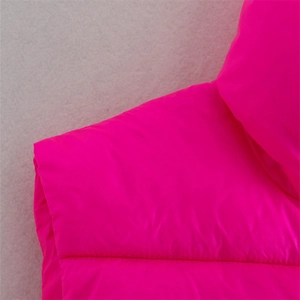 Detail view of pink quilted puffer vest featuring high collar and horizontal stitching