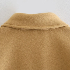 Close-up of lapel collar and shoulder stitching on a thick camel wool blend overcoat