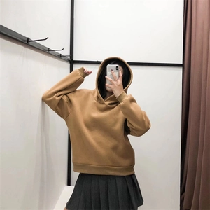 Detail view of camel oversized fleece hoodie featuring ribbed cuffs and pleated sleeve accents