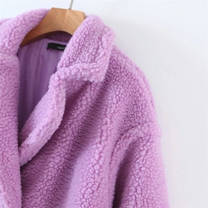 Detailed close-up of lapel collar and plush texture on light purple faux fur coat