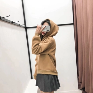 Detail of khaki oversized hoodie featuring ribbed cuffs and slouchy ruched shoulder design