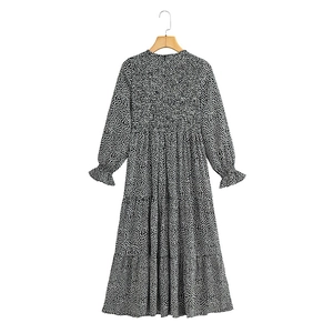 Detailed view of elastic cuffs and tiered hem on this polka dot maxi dress